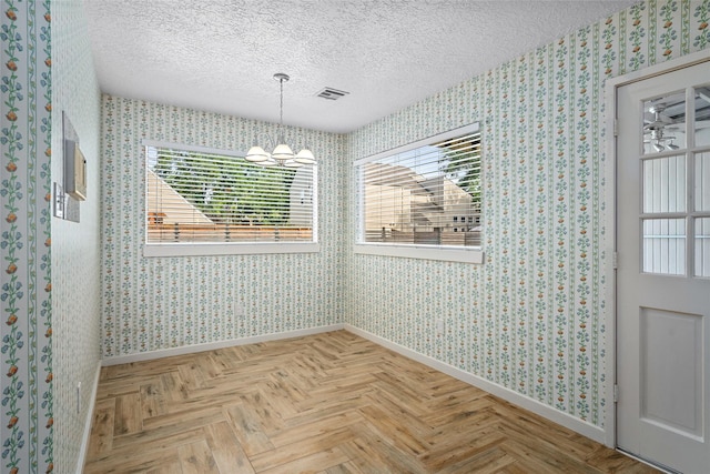 707 Center Hill Dr, Houston, TX 77079 - unfurnished dining area with baseboards, wallpapered walls, a textured ceiling, and plenty of natural light