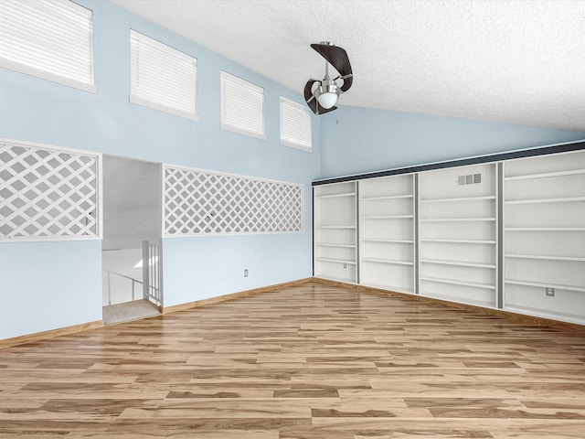 707 Center Hill Dr, Houston, TX 77079 - unfurnished bedroom with wood finished floors, high vaulted ceiling, a textured ceiling, a closet, and a ceiling fan