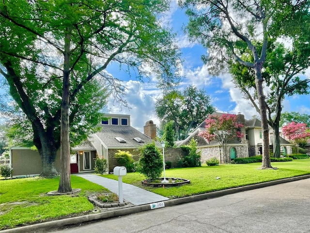 707 Center Hill Dr, Houston, TX 77079 - view of front of home with a front lawn, concrete driveway, and stone siding