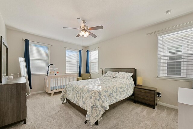5514 Oriente Ln, Houston, TX 77023 - bedroom featuring light carpet, multiple windows, and baseboards