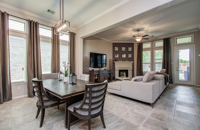 3111 Jane Way, Richmond, TX 77406 - dining area with crown molding, a fireplace, a ceiling fan, baseboards, and light tile patterned flooring