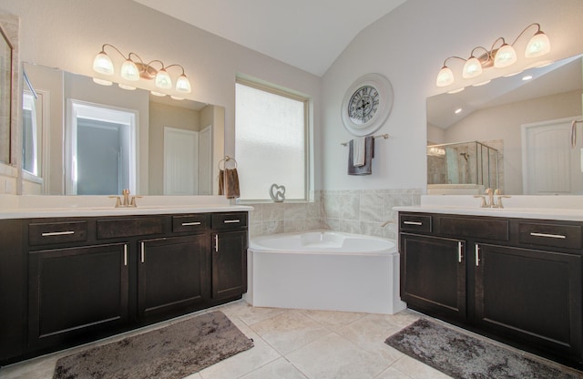 3111 Jane Way, Richmond, TX 77406 - full bathroom with lofted ceiling, a shower stall, a bath, two vanities, and tile patterned floors