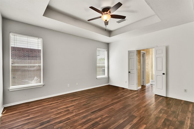 20434 Willow Trace Dr, Cypress, TX 77433 - spare room with a raised ceiling, dark wood-style floors, a ceiling fan, and baseboards