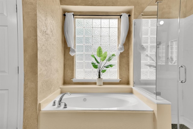 20434 Willow Trace Dr, Cypress, TX 77433 - full bathroom featuring a shower stall, a bath, and a textured wall