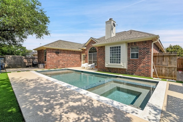 20434 Willow Trace Dr, Cypress, TX 77433 - rear view of property featuring brick siding, a patio area, a chimney, and a shingled roof