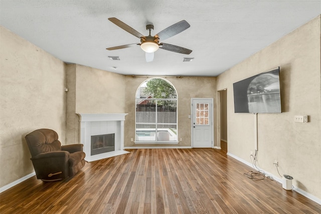 20434 Willow Trace Dr, Cypress, TX 77433 - unfurnished living room featuring wood finished floors, a fireplace, a ceiling fan, and baseboards