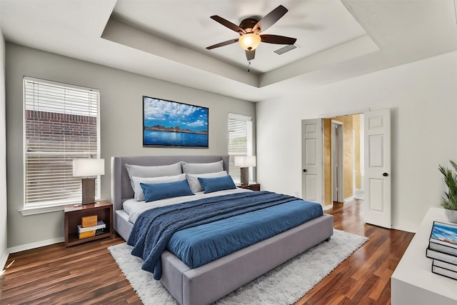 20434 Willow Trace Dr, Cypress, TX 77433 - bedroom featuring a raised ceiling, dark wood-type flooring, baseboards, and ceiling fan