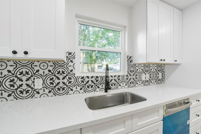 4330 Heite St, Houston, TX 77022 - kitchen with a sink, dishwasher, tasteful backsplash, and white cabinetry