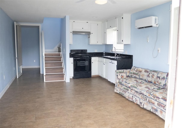 7301 Ave K, Houston, TX 77011 - kitchen with black / electric stove, a wall mounted air conditioner, under cabinet range hood, a sink, and white cabinetry