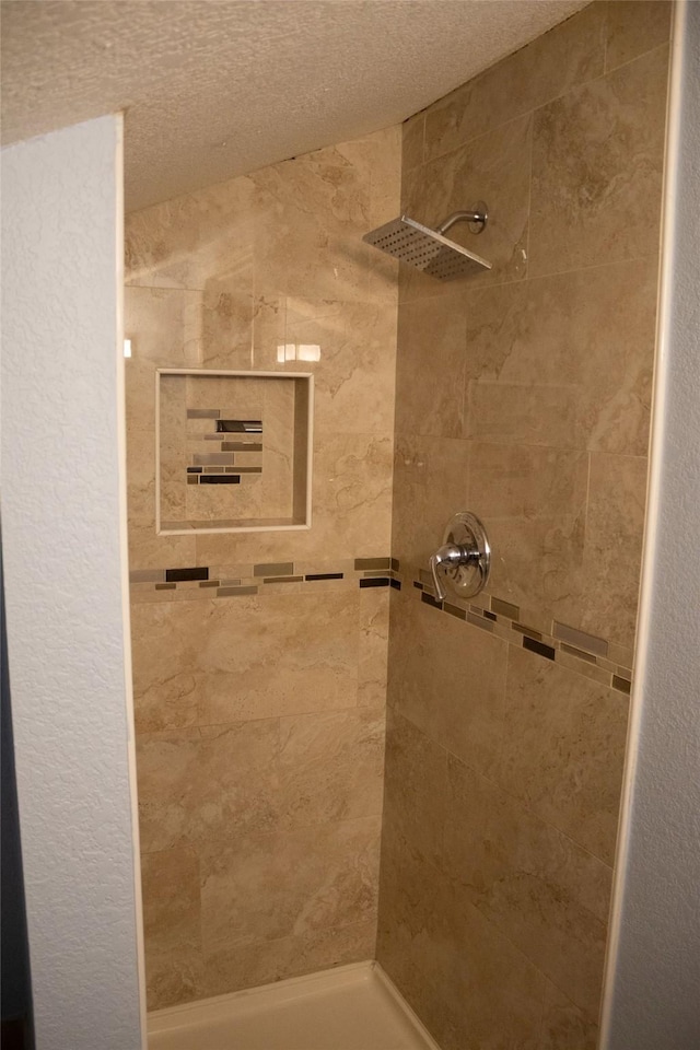 7301 Ave K, Houston, TX 77011 - full bathroom with a tile shower and a textured ceiling