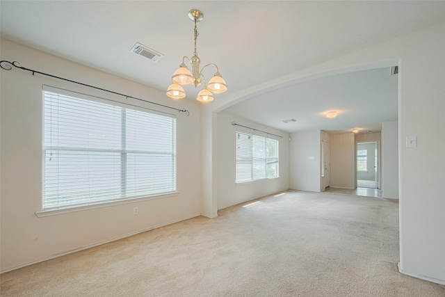 427 Sunset Colony Dr, Rosharon, TX 77583 - empty room featuring a chandelier, carpet floors, arched walkways, and baseboards