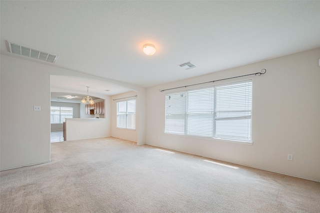 427 Sunset Colony Dr, Rosharon, TX 77583 - unfurnished living room featuring a chandelier and carpet flooring