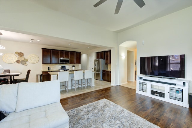 223 Summer Gate Ct, Rosenberg, TX 77469 - living room with ceiling fan, wood finished floors, arched walkways, recessed lighting, and baseboards