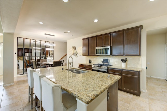 223 Summer Gate Ct, Rosenberg, TX 77469 - kitchen featuring stainless steel appliances, a sink, decorative backsplash, light tile patterned floors, and recessed lighting