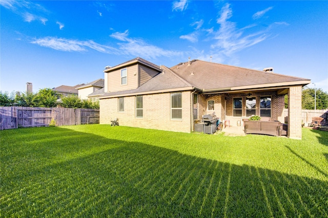223 Summer Gate Ct, Rosenberg, TX 77469 - rear view of property featuring brick siding, a patio area, an outdoor hangout area, and a shingled roof
