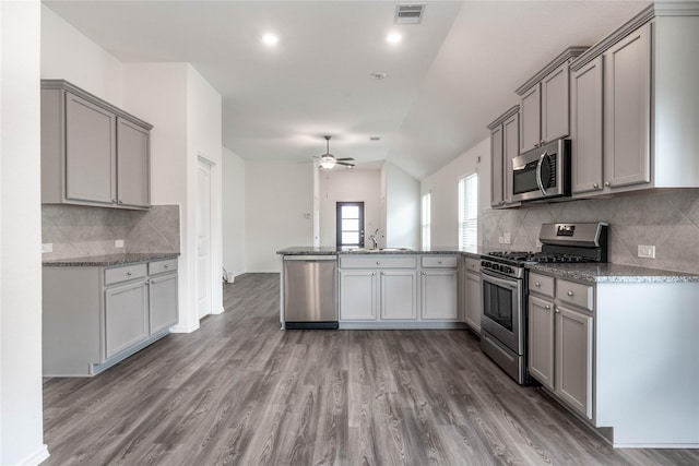 10106 Granite Grove Ln, Richmond, TX 77406 - kitchen featuring appliances with stainless steel finishes, a sink, a peninsula, gray cabinets, and ceiling fan