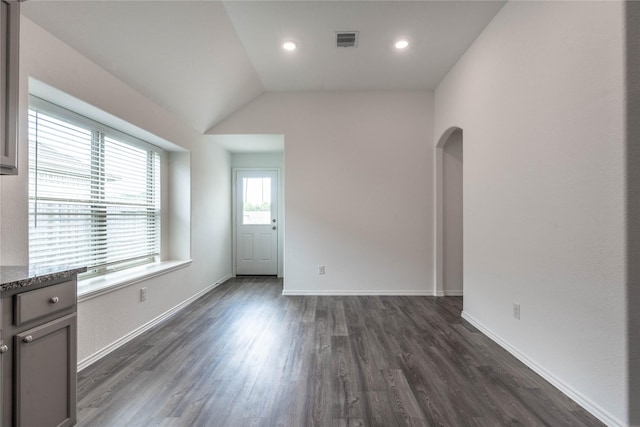 10106 Granite Grove Ln, Richmond, TX 77406 - spare room featuring dark wood-style floors, arched walkways, baseboards, lofted ceiling, and recessed lighting