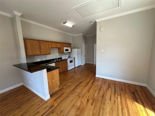 508 W Clay St, Houston, TX 77019 - kitchen featuring white appliances, wood finished floors, baseboards, brown cabinetry, and crown molding