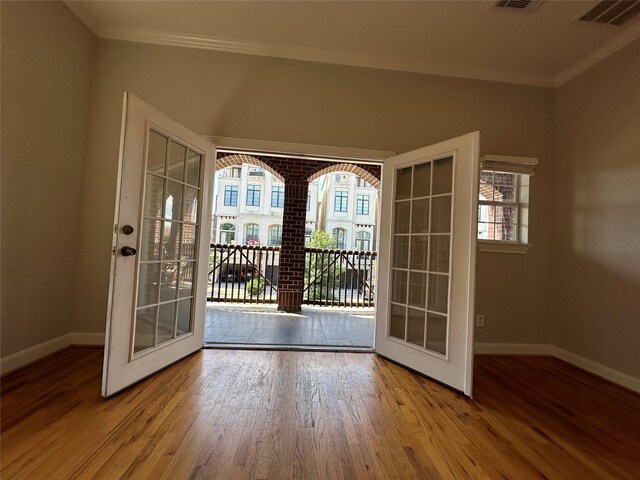 508 W Clay St, Houston, TX 77019 - doorway to outside featuring french doors, crown molding, baseboards, and wood finished floors
