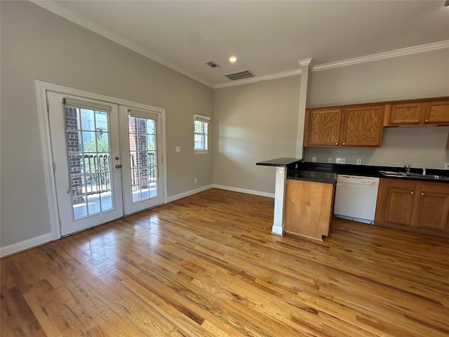 508 W Clay St, Houston, TX 77019 - kitchen featuring dishwasher, a sink, crown molding, light wood-type flooring, and brown cabinetry