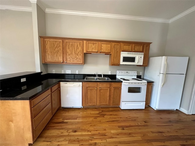 508 W Clay St, Houston, TX 77019 - kitchen featuring white appliances, crown molding, wood finished floors, dark countertops, and a sink