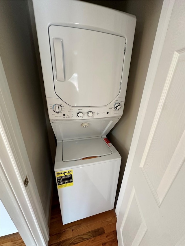 508 W Clay St, Houston, TX 77019 - laundry room featuring stacked washing machine and dryer and wood finished floors
