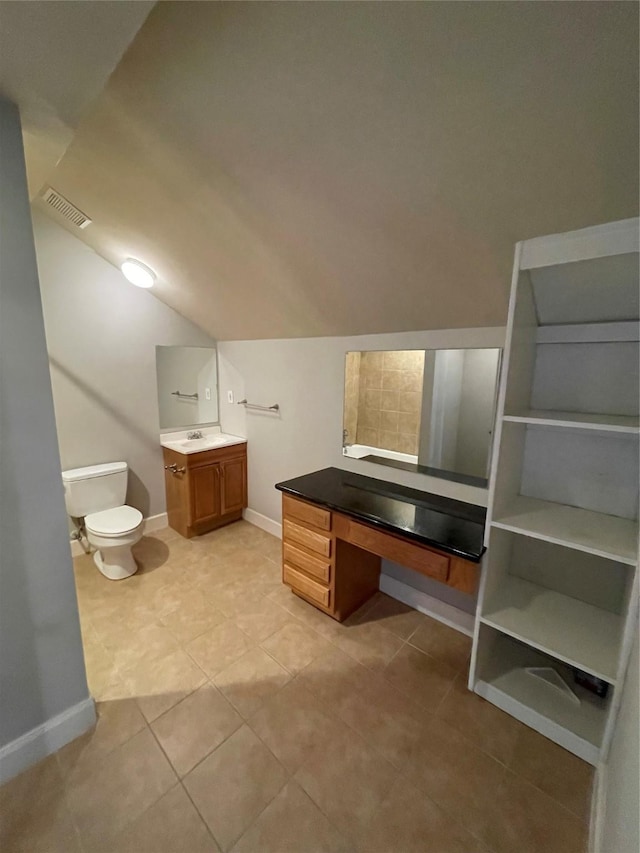 508 W Clay St, Houston, TX 77019 - bathroom featuring lofted ceiling, toilet, vanity, tile patterned flooring, and baseboards