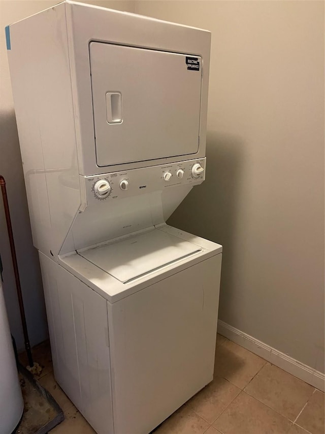 508 W Clay St, Houston, TX 77019 - washroom featuring estacked washer and dryer, baseboards, and light tile patterned floors