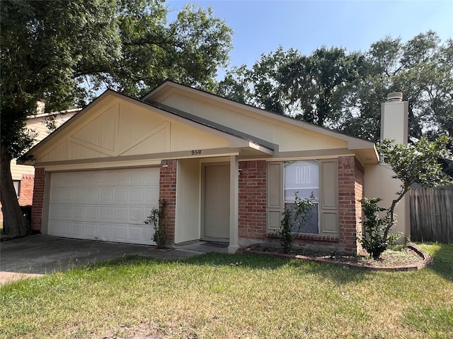 958 Grand Junction Dr, Katy, TX 77450 - view of front facade featuring brick siding, an attached garage, asphalt driveway, and a chimney