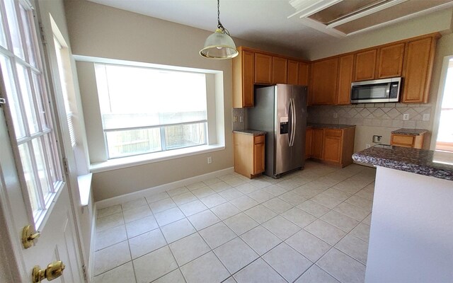 2707 Sun Beam Ct, Pearland, TX 77584 - kitchen with appliances with stainless steel finishes, healthy amount of natural light, and light tile patterned flooring