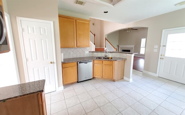 2707 Sun Beam Ct, Pearland, TX 77584 - kitchen with dishwasher, a ceiling fan, a peninsula, a sink, and a fireplace