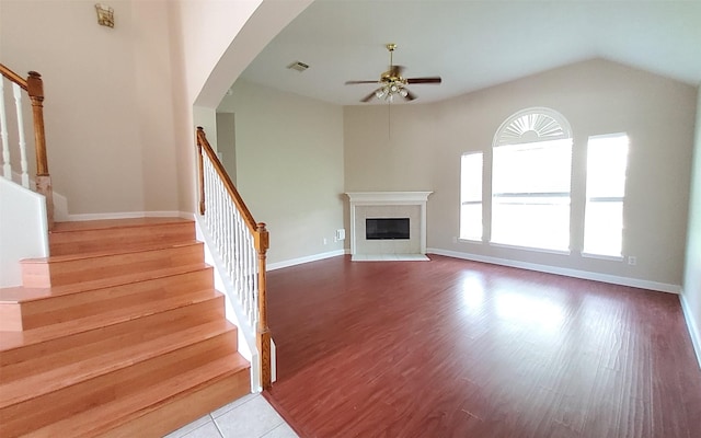 2707 Sun Beam Ct, Pearland, TX 77584 - unfurnished living room featuring ceiling fan, stairs, a high end fireplace, wood finished floors, and vaulted ceiling