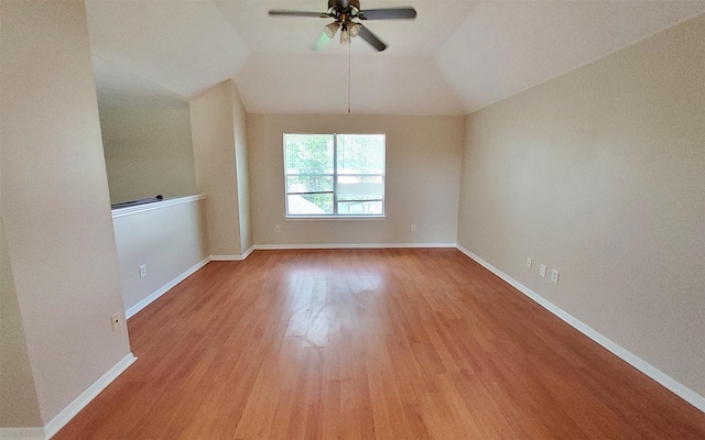 2707 Sun Beam Ct, Pearland, TX 77584 - spare room featuring wood finished floors, ceiling fan, vaulted ceiling, and baseboards