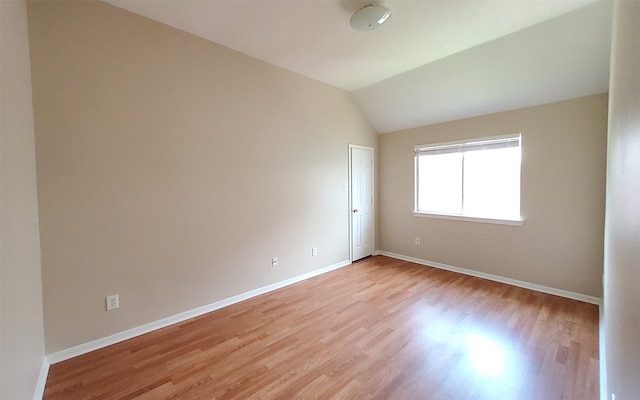 2707 Sun Beam Ct, Pearland, TX 77584 - spare room with light wood finished floors, baseboards, and vaulted ceiling