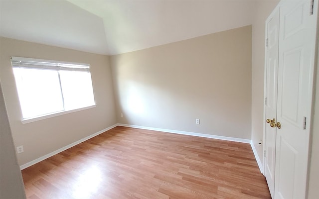 2707 Sun Beam Ct, Pearland, TX 77584 - unfurnished room with light wood-style flooring, vaulted ceiling, and baseboards