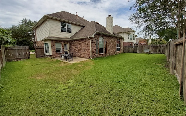 2707 Sun Beam Ct, Pearland, TX 77584 - rear view of property featuring brick siding, a chimney, a patio area, and roof with shingles