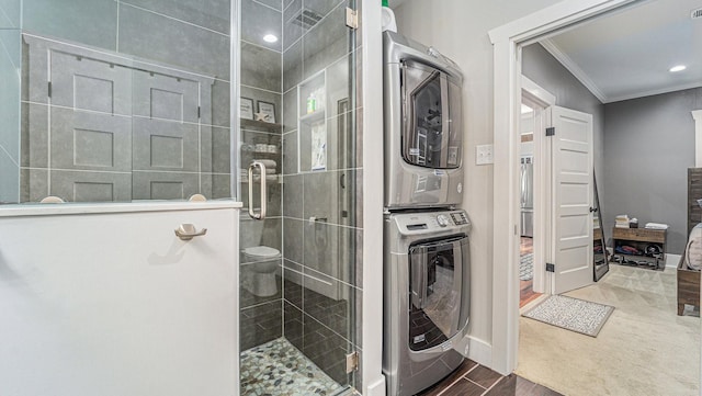 405 N Grace St N, Houston, TX 77003 - bathroom with stacked washer and clothes dryer, crown molding, a shower stall, baseboards, and wood finished floors