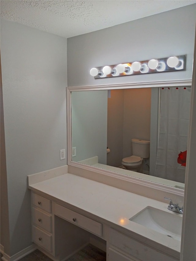 800 Country Place Dr Unit 909, Houston, TX 77079 - bathroom featuring toilet, a textured ceiling, and vanity