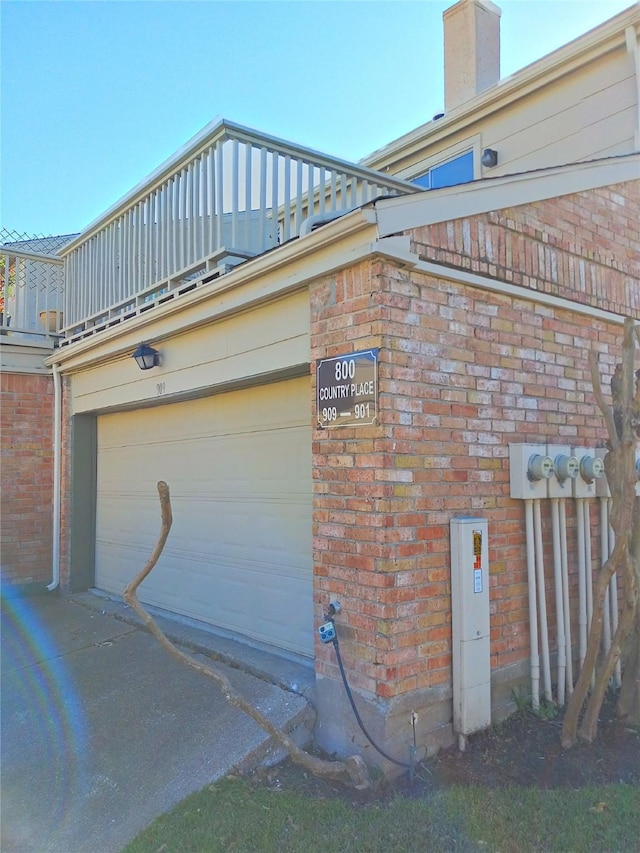 800 Country Place Dr Unit 909, Houston, TX 77079 - view of property exterior featuring brick siding, a chimney, and driveway