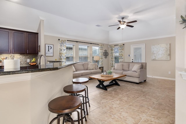 23118 Mestina Knoll Dr, Porter, TX 77365 - living area with ceiling fan, crown molding, light tile patterned floors, and baseboards