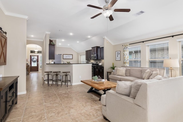 23118 Mestina Knoll Dr, Porter, TX 77365 - living room featuring ornamental molding, healthy amount of natural light, a ceiling fan, lofted ceiling, and arched walkways