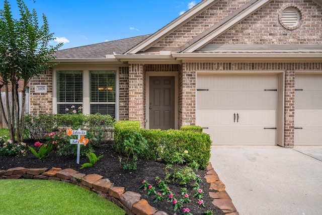 31870 Forest Park Trl, Conroe, TX 77385 - view of front of property featuring brick siding, driveway, and a garage