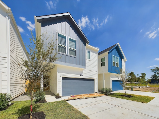 5020 Broom St, Houston, TX 77091 - contemporary home featuring board and batten siding, an attached garage, and concrete driveway