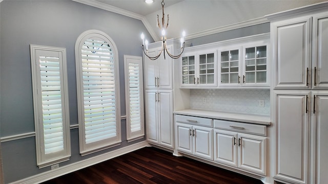 53 S Calla Lily Ct, Lake Jackson, TX 77566 - unfurnished dining area with a chandelier, dark wood finished floors, and ornamental molding