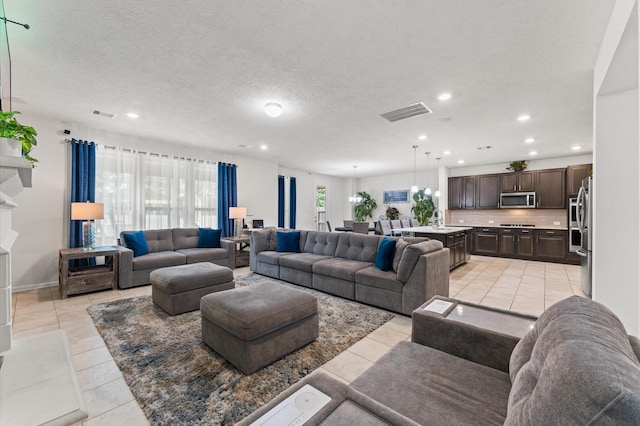 1164 Clonmore Ct, Conroe, TX 77304 - living room with recessed lighting, light tile patterned floors, a textured ceiling, and baseboards