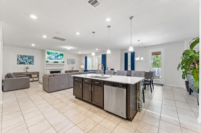1164 Clonmore Ct, Conroe, TX 77304 - kitchen with stainless steel dishwasher, a sink, light tile patterned floors, light countertops, and dark brown cabinets
