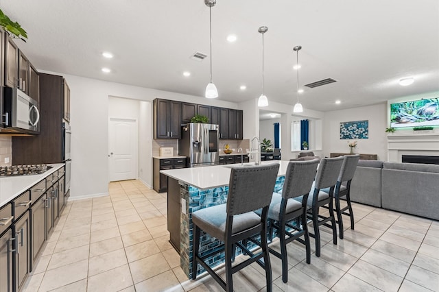 1164 Clonmore Ct, Conroe, TX 77304 - kitchen with appliances with stainless steel finishes, light countertops, light tile patterned floors, tasteful backsplash, and recessed lighting
