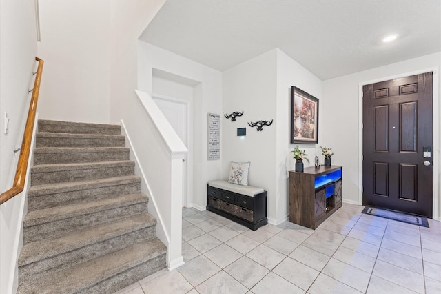 1164 Clonmore Ct, Conroe, TX 77304 - entrance foyer featuring stairway, light tile patterned floors, and baseboards