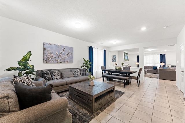 1164 Clonmore Ct, Conroe, TX 77304 - living area with light tile patterned floors and healthy amount of natural light