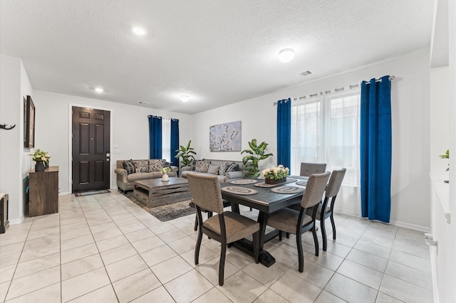 1164 Clonmore Ct, Conroe, TX 77304 - dining space featuring a textured ceiling, light tile patterned flooring, baseboards, and recessed lighting